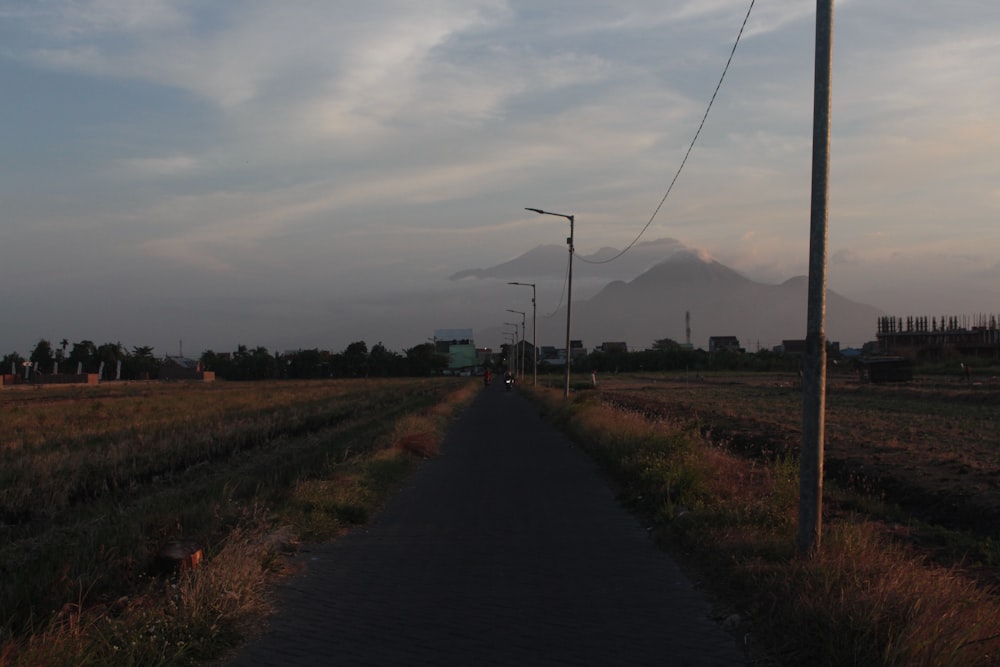 a long road with a mountain in the background