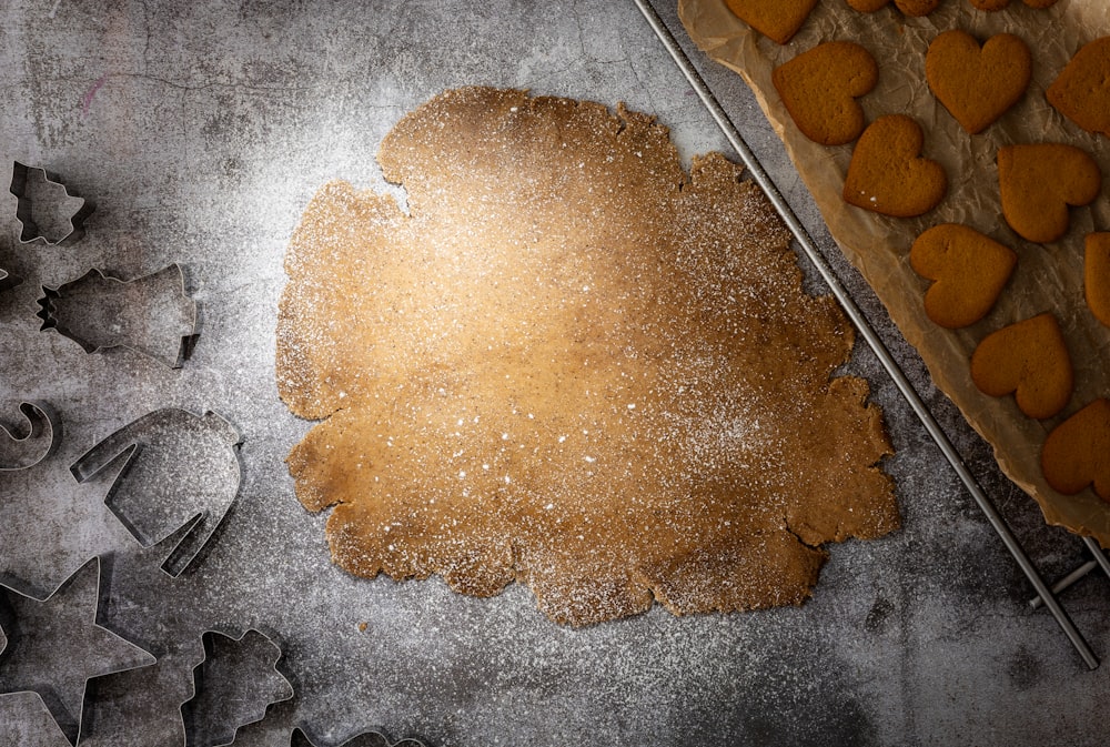 a cookie dough and cookie cutters on a table