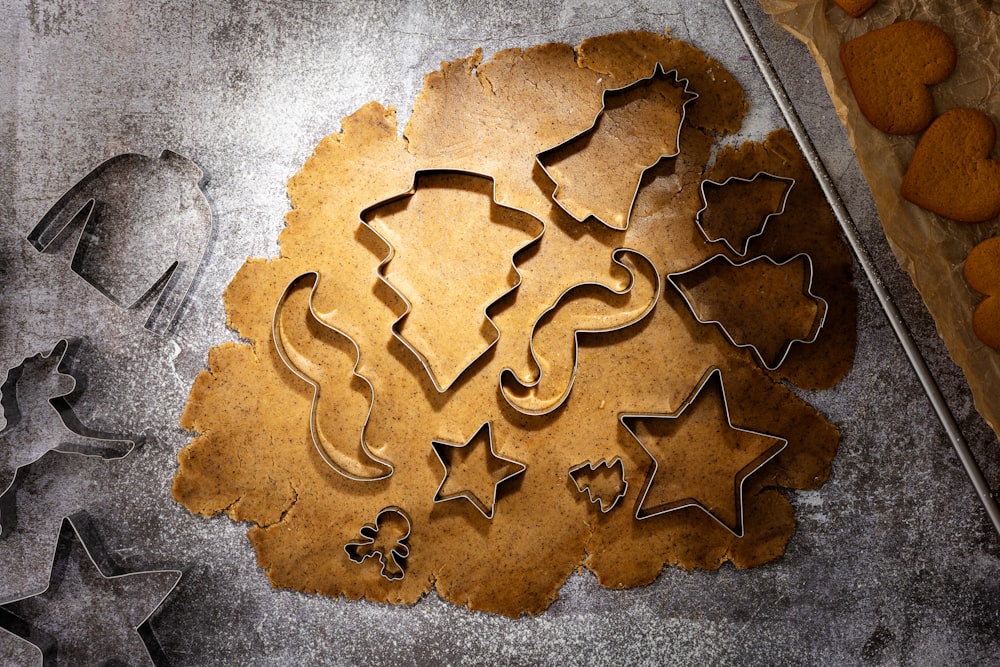 cookie cutters and cookies on a baking sheet