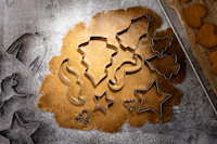 Cookie cutter shapes pressed into rolled-out dough