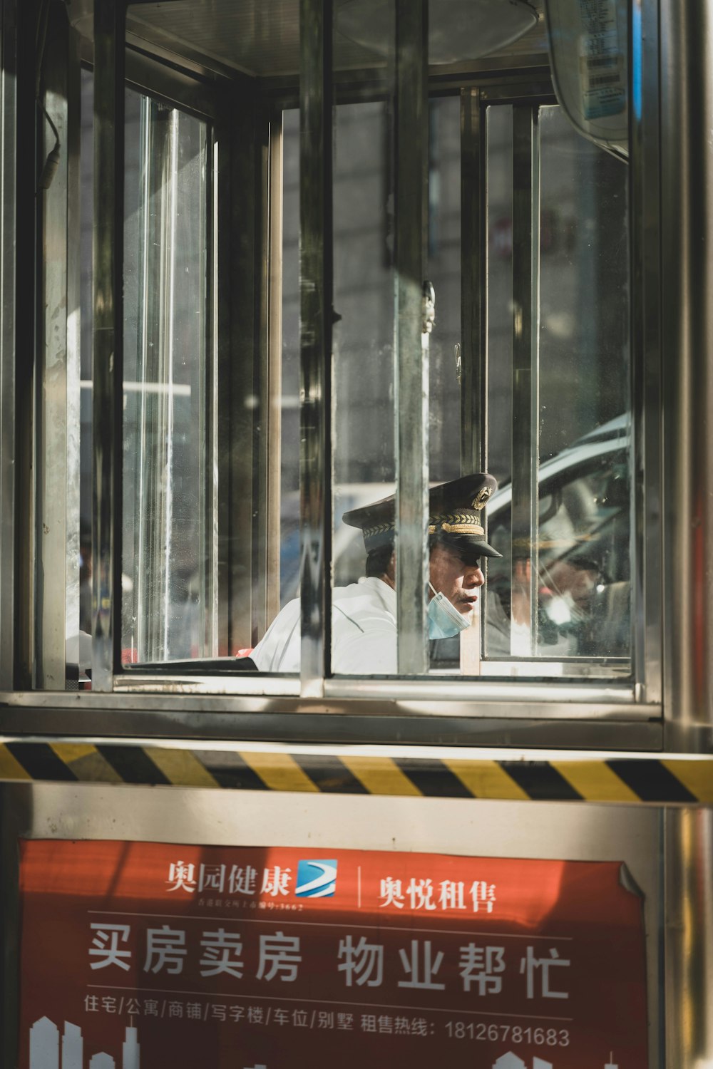 a man in a police uniform looking out of a window