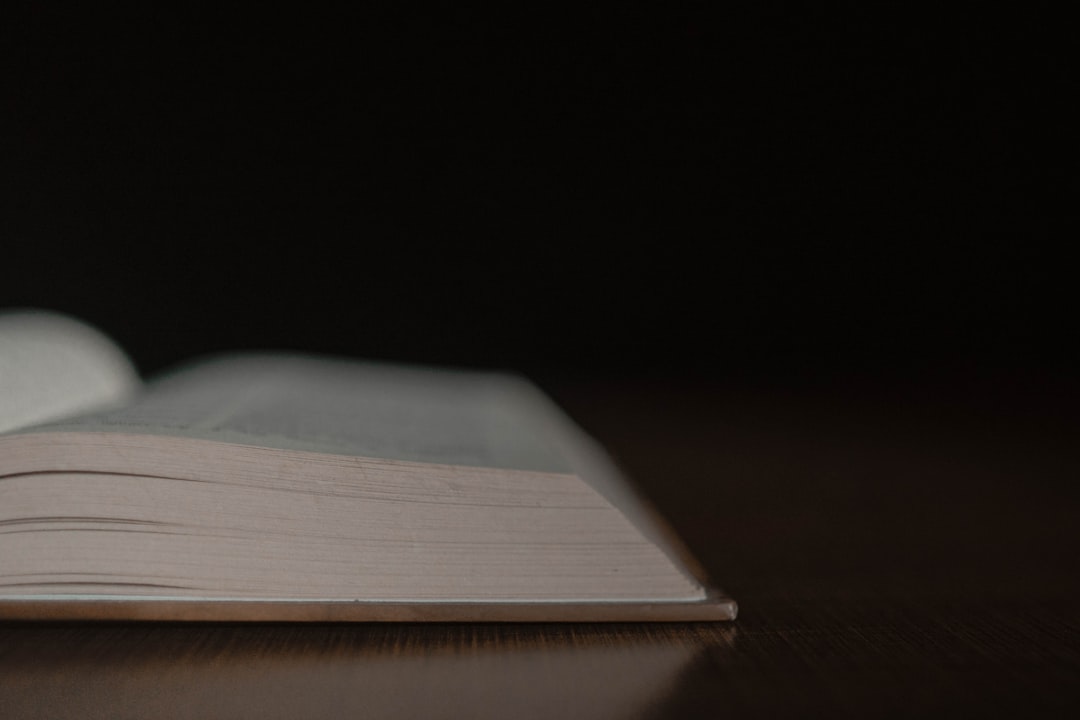 an open book sitting on top of a wooden table,