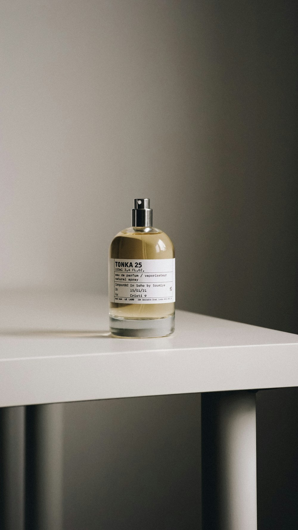 a bottle of liquid sitting on top of a white table