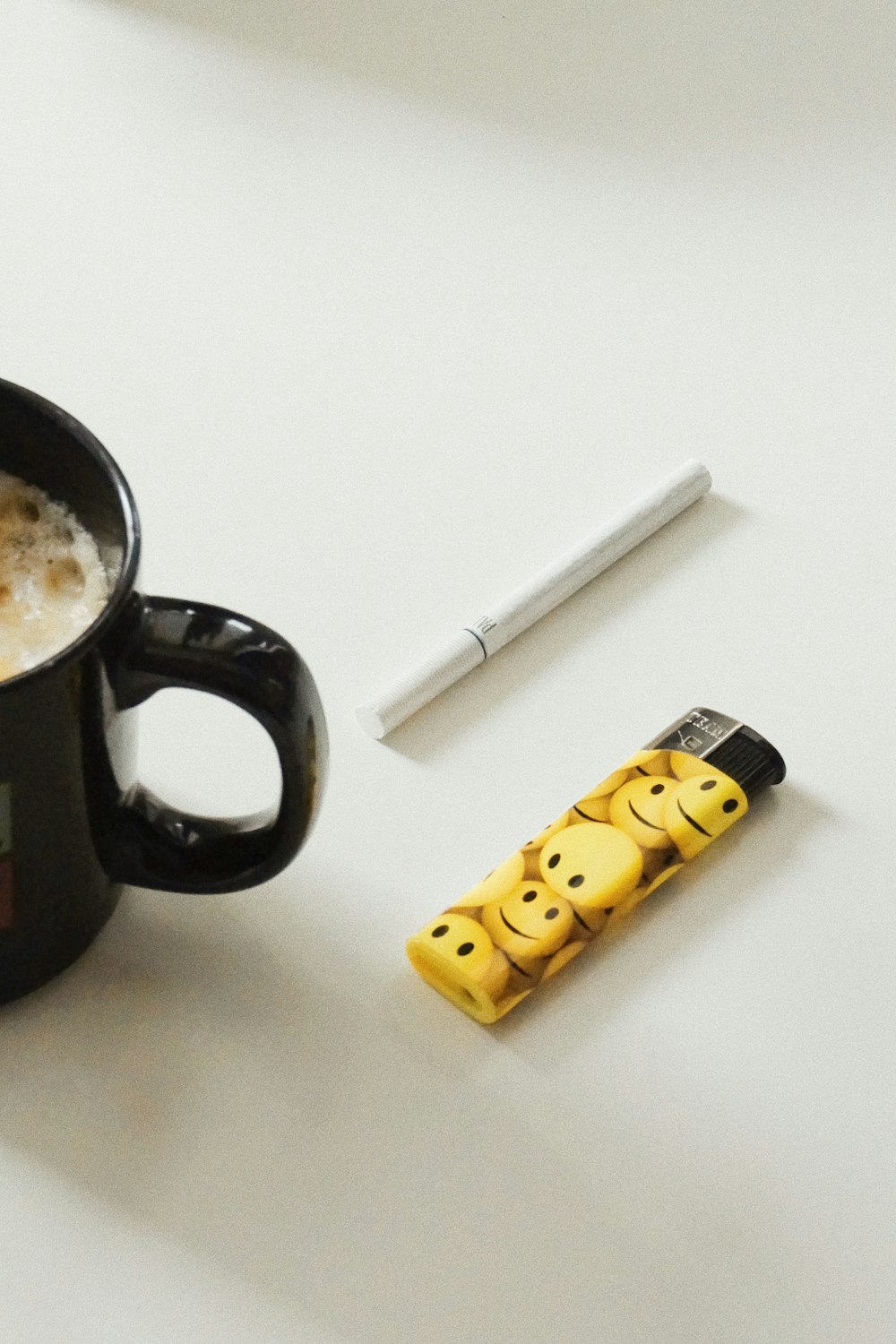 a cup of coffee with a smiley face drawn on it