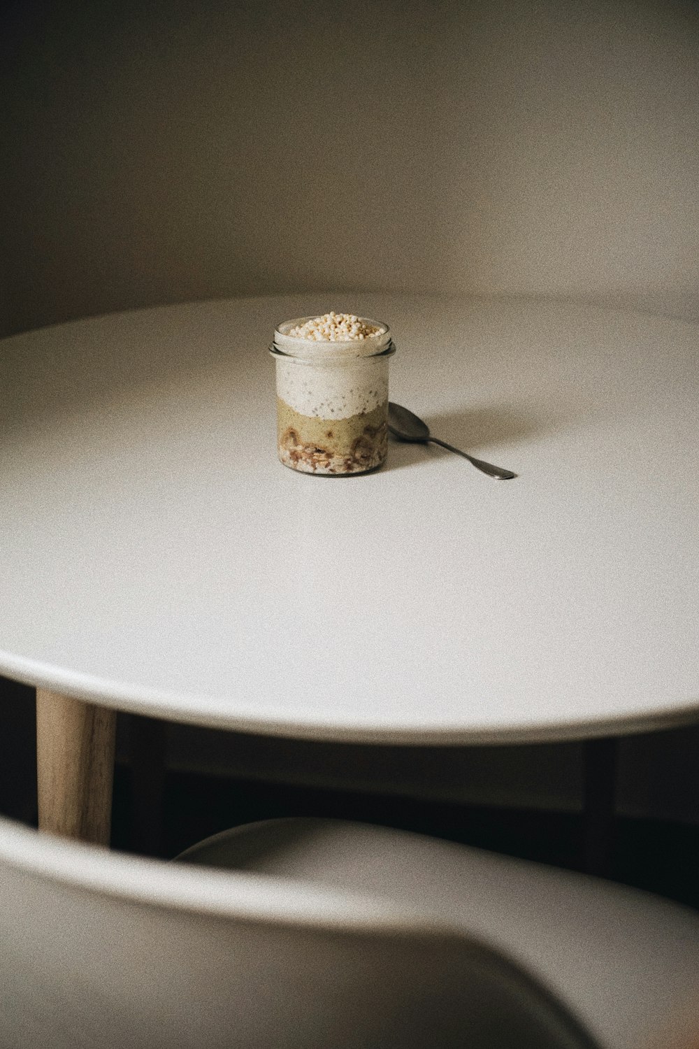 a white table with a jar of food on top of it