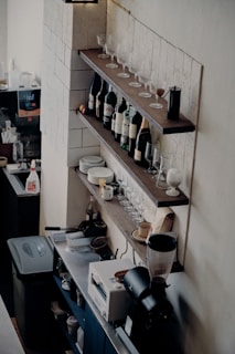 A cozy corner of the restaurant with shelves lined with various bottled beverages.