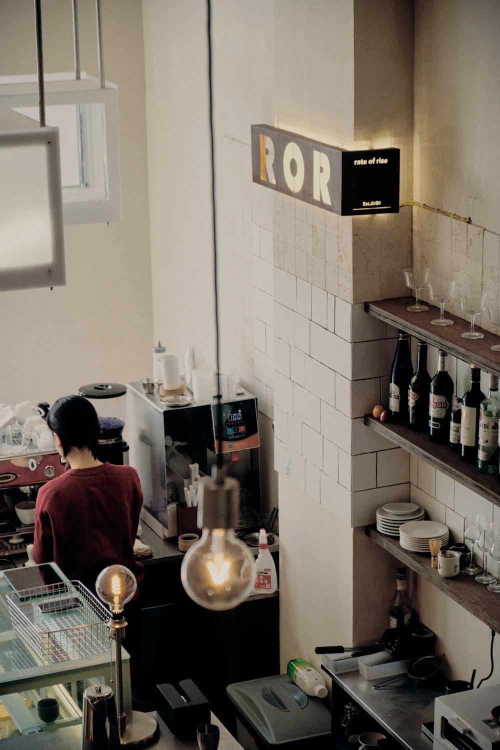 a woman standing at a counter in a restaurant