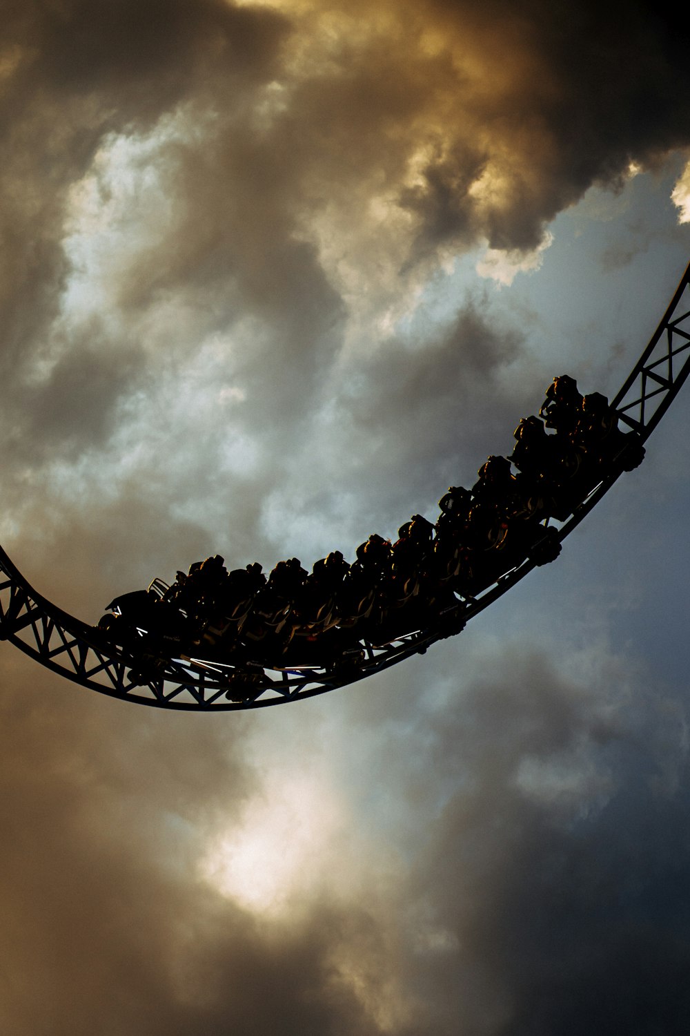 a roller coaster in the middle of a cloudy sky