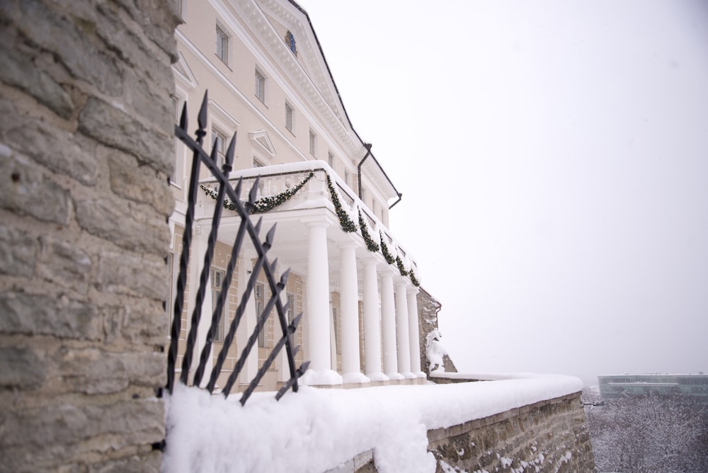 a stone building with a black iron fence in front of it