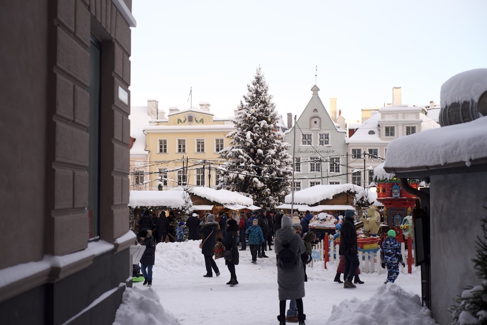 a group of people walking down a snow covered street