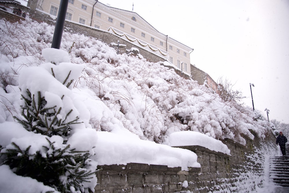 a man is walking up a snowy hill