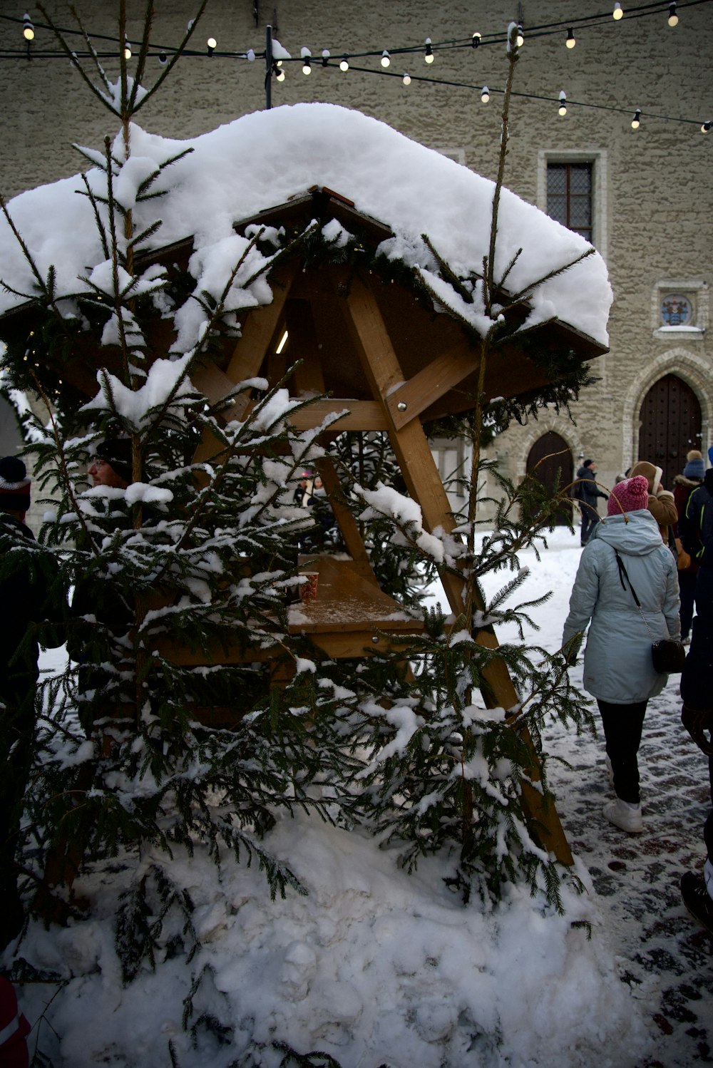 a group of people standing around a christmas tree