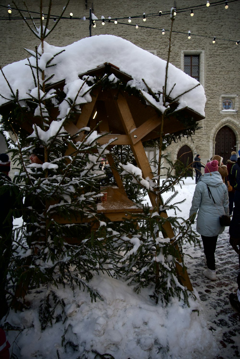 Un grupo de personas de pie alrededor de un árbol de Navidad