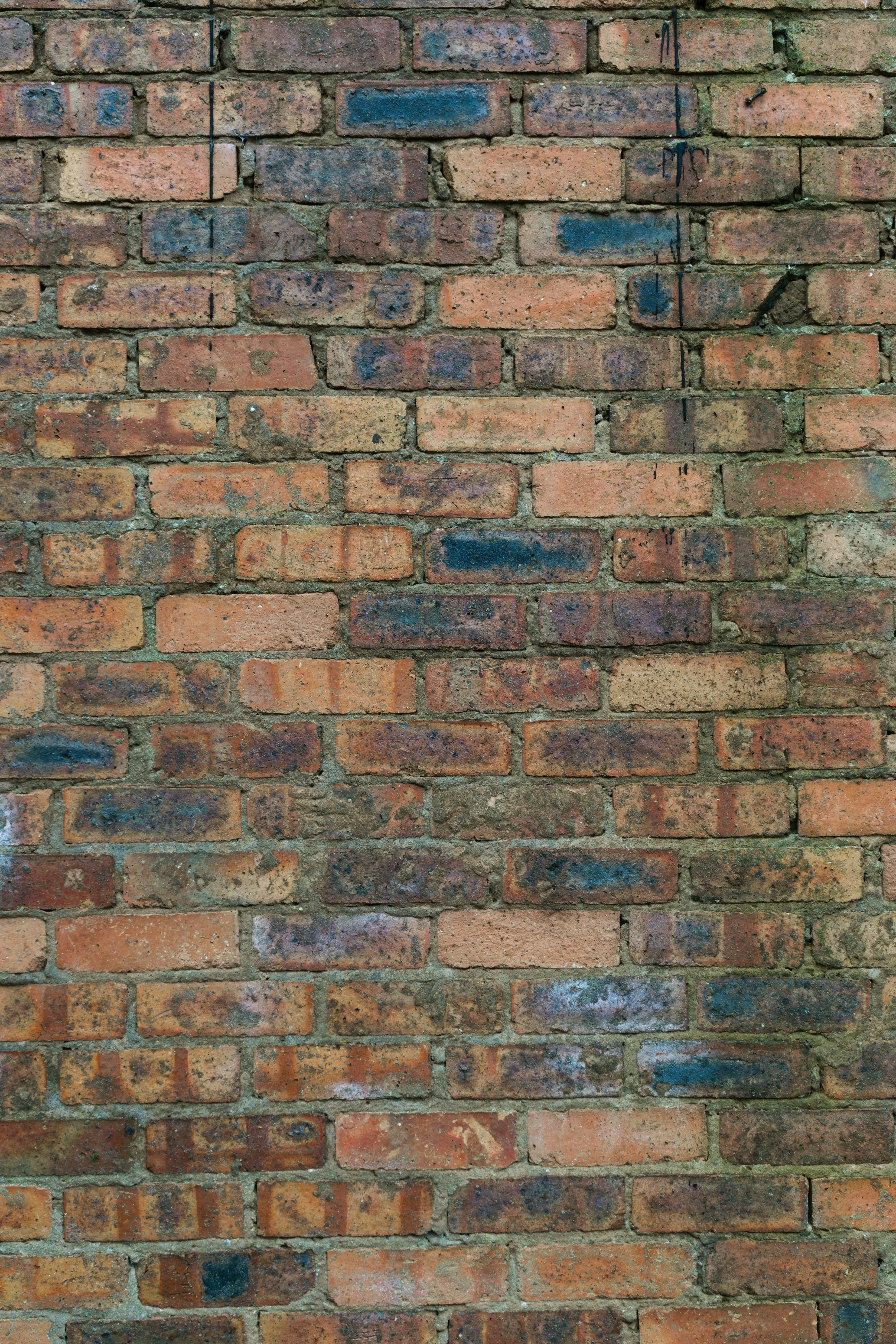a brick wall with a clock on the side of it