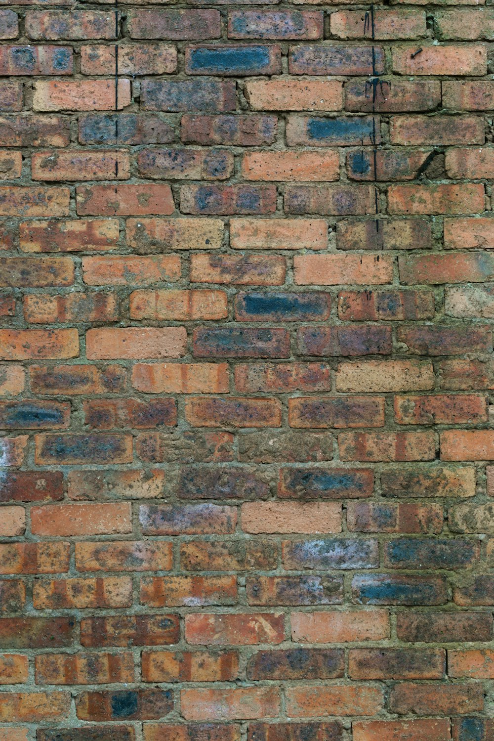 a brick wall with a clock on the side of it