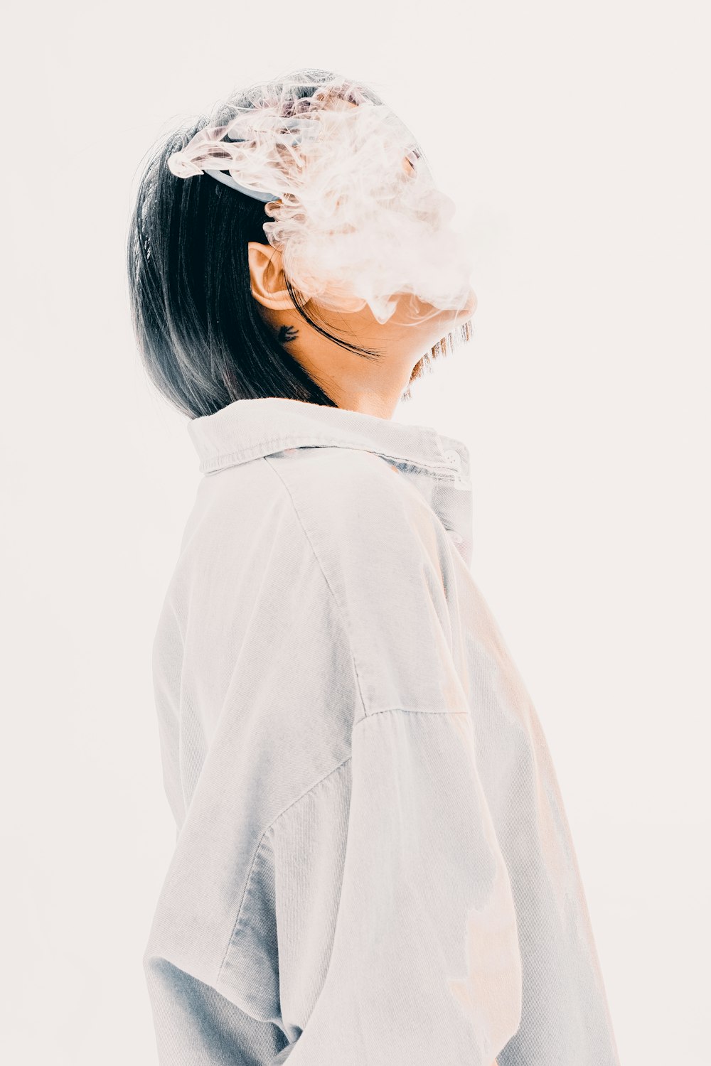 a woman wearing a white jacket and a white background