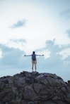 a person standing on top of a rocky hill