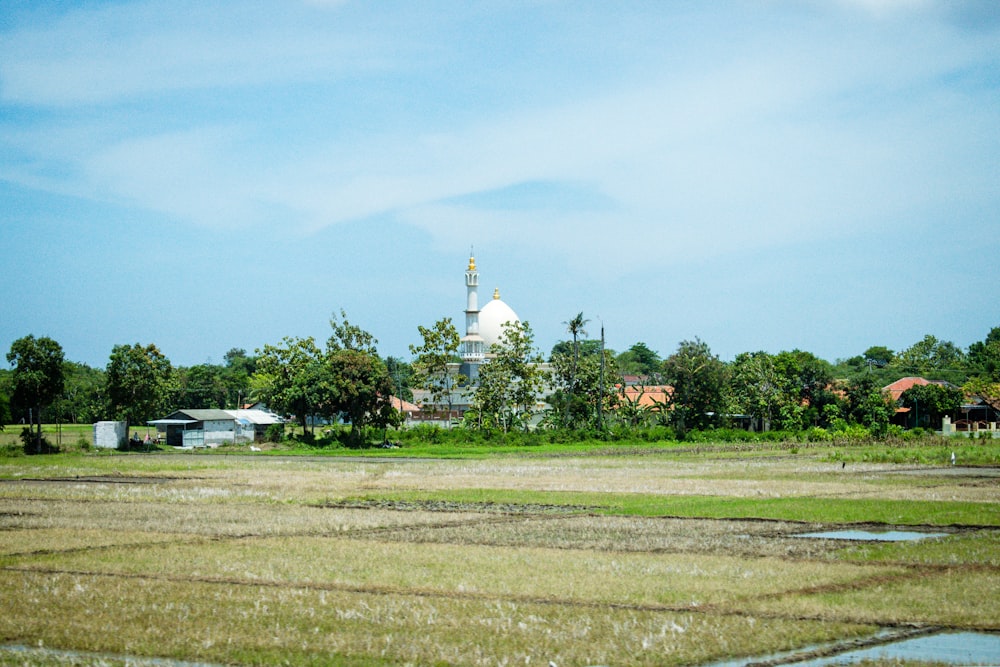 a field with a building in the background