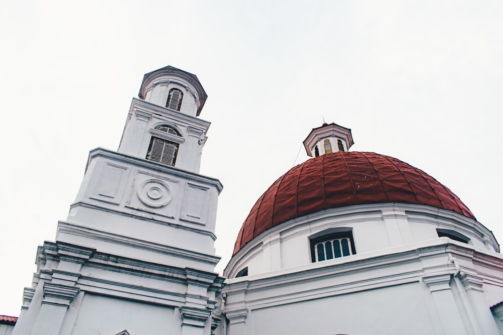 a large white building with a red dome