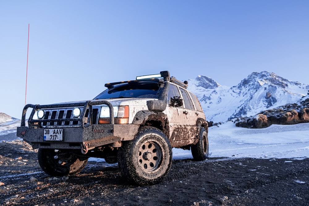 a vehicle is parked on a snowy mountain