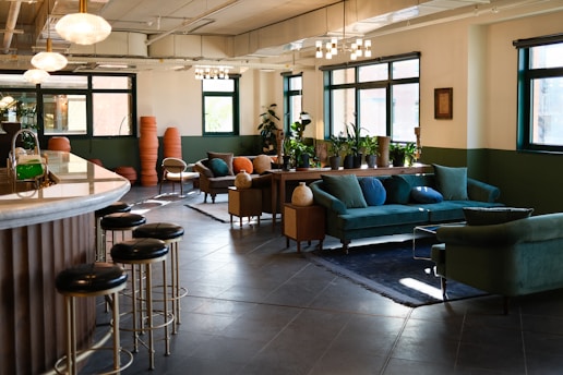 a living room filled with furniture and lots of windows