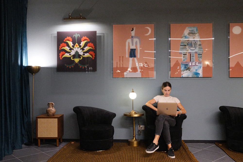 a person sitting in a chair with a laptop