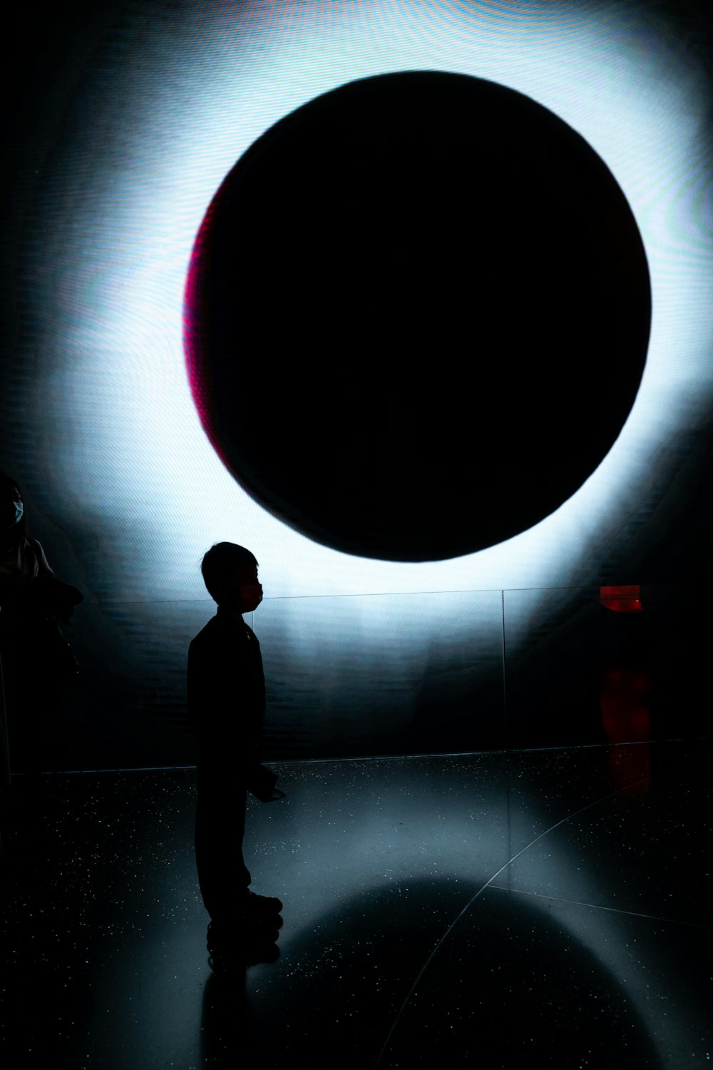 a person standing in front of a large object