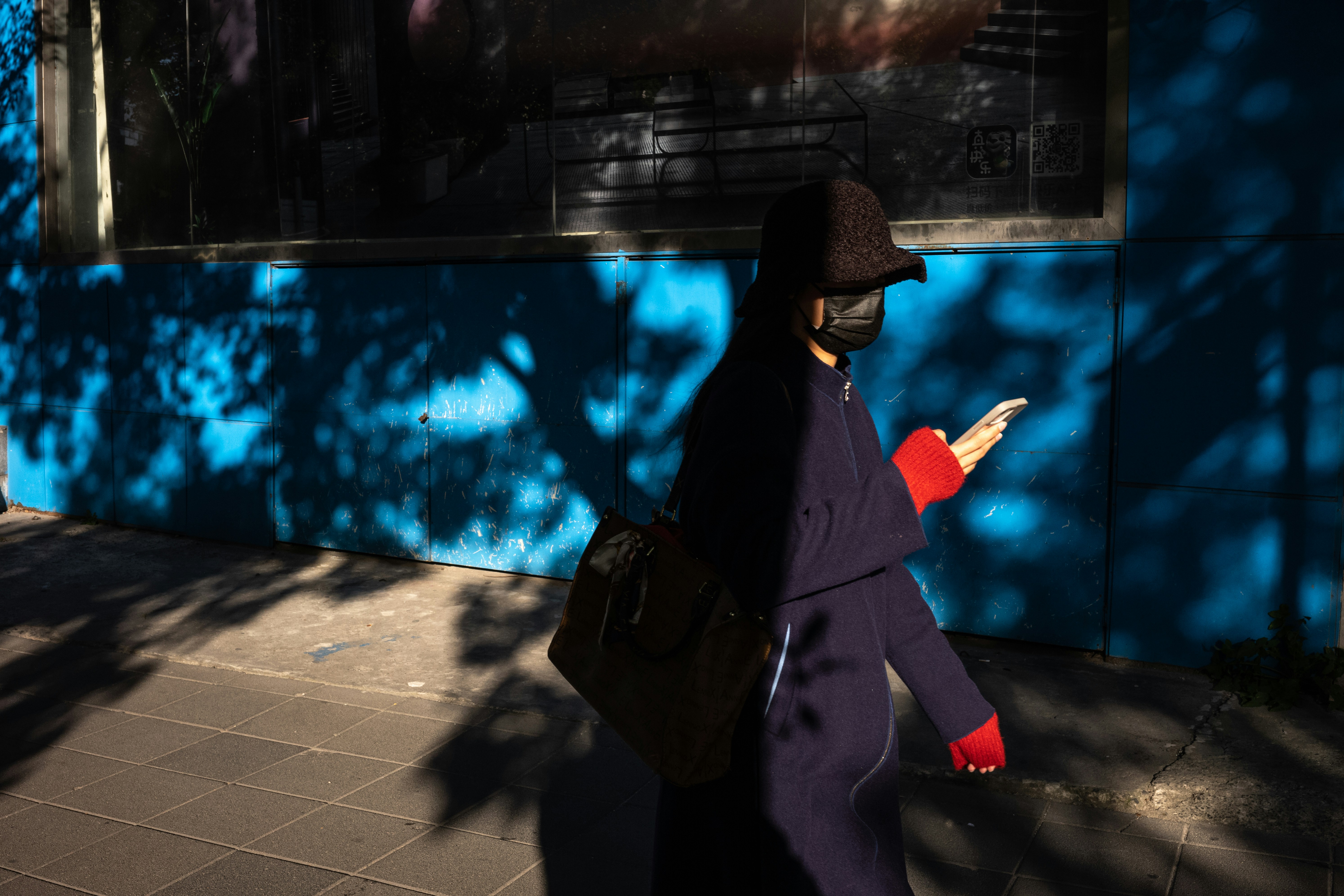 A person holds a smartphone displaying a map of a residential neighborhood, representing the critical importance of local search and GEO targeting for real estate.