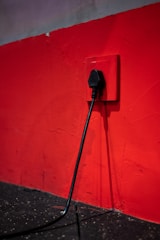 Electrician carefully installing a new power point in a cozy living room.