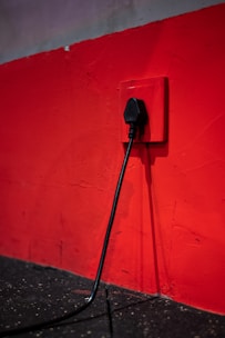 Close-up of hands installing new electrical sockets in a living room.