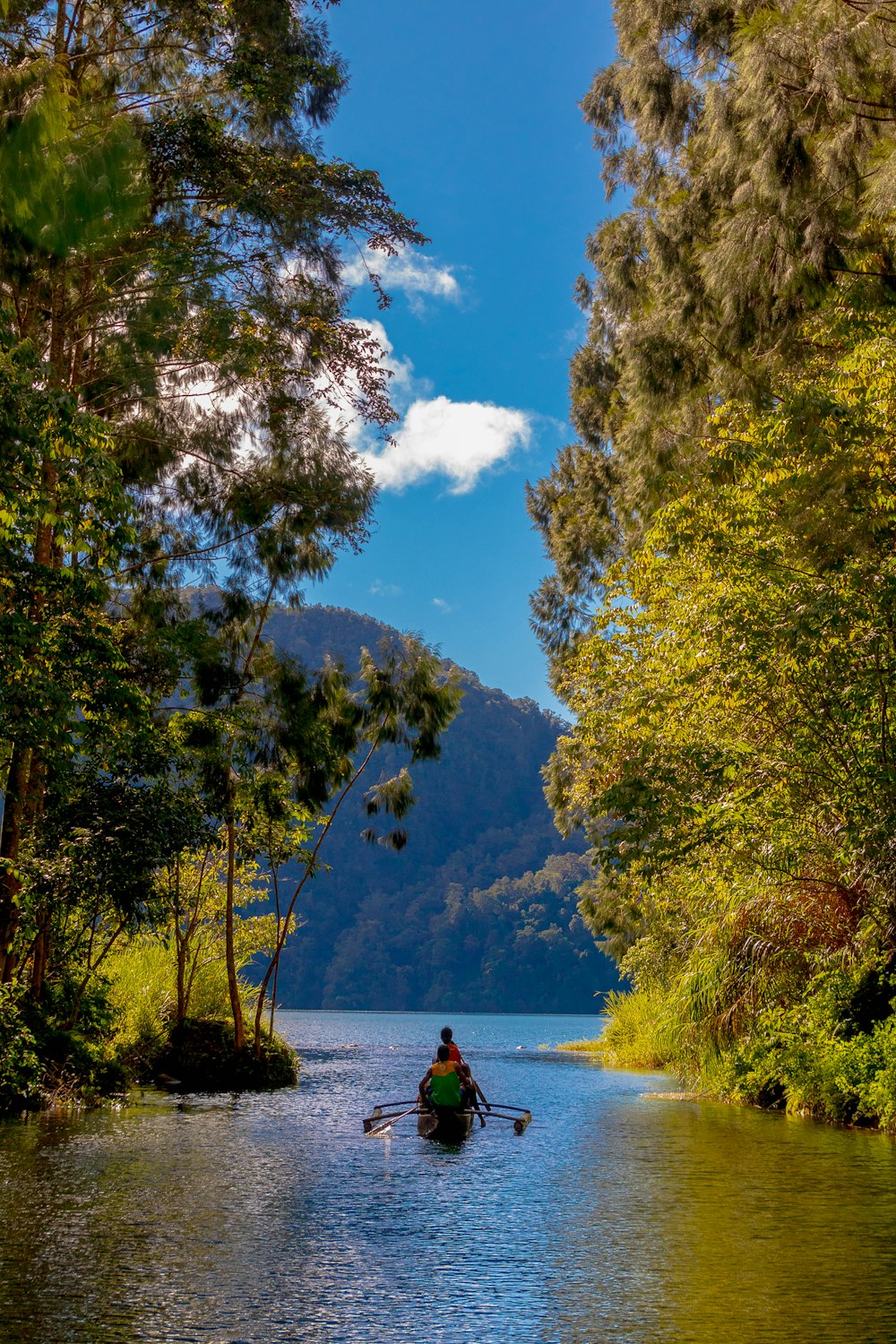 a person rowing a boat down a river