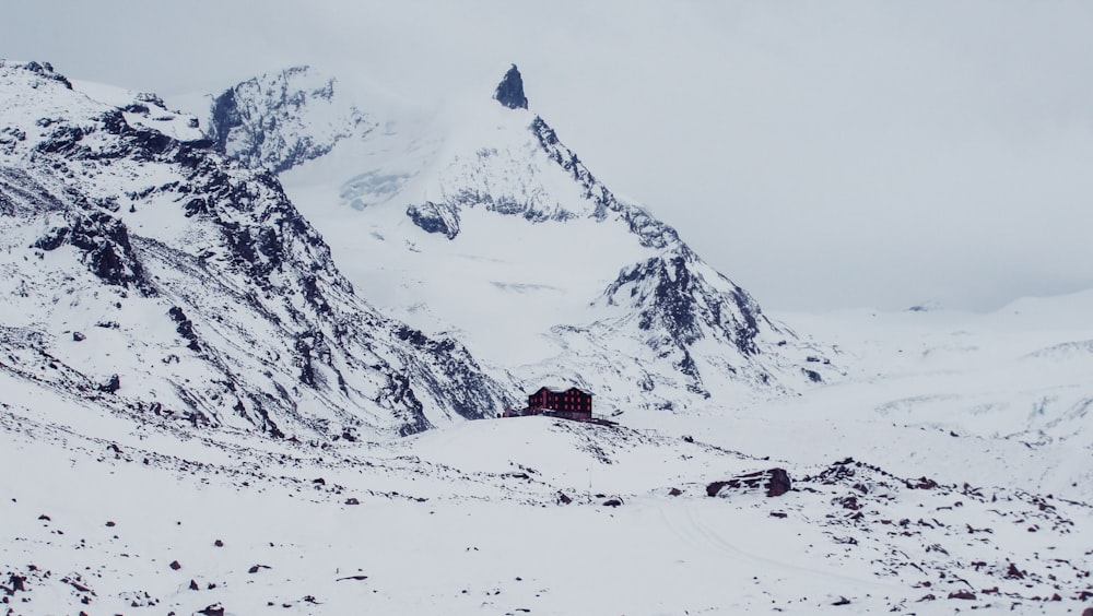 a house in the middle of a snowy mountain