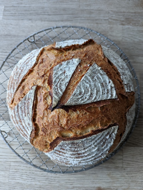 Artisan breads cooling on a wire rack in a cozy bakery setting