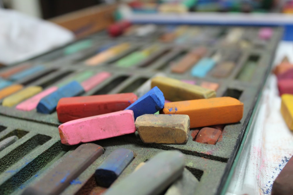 a close up of a tray of crayons on a table