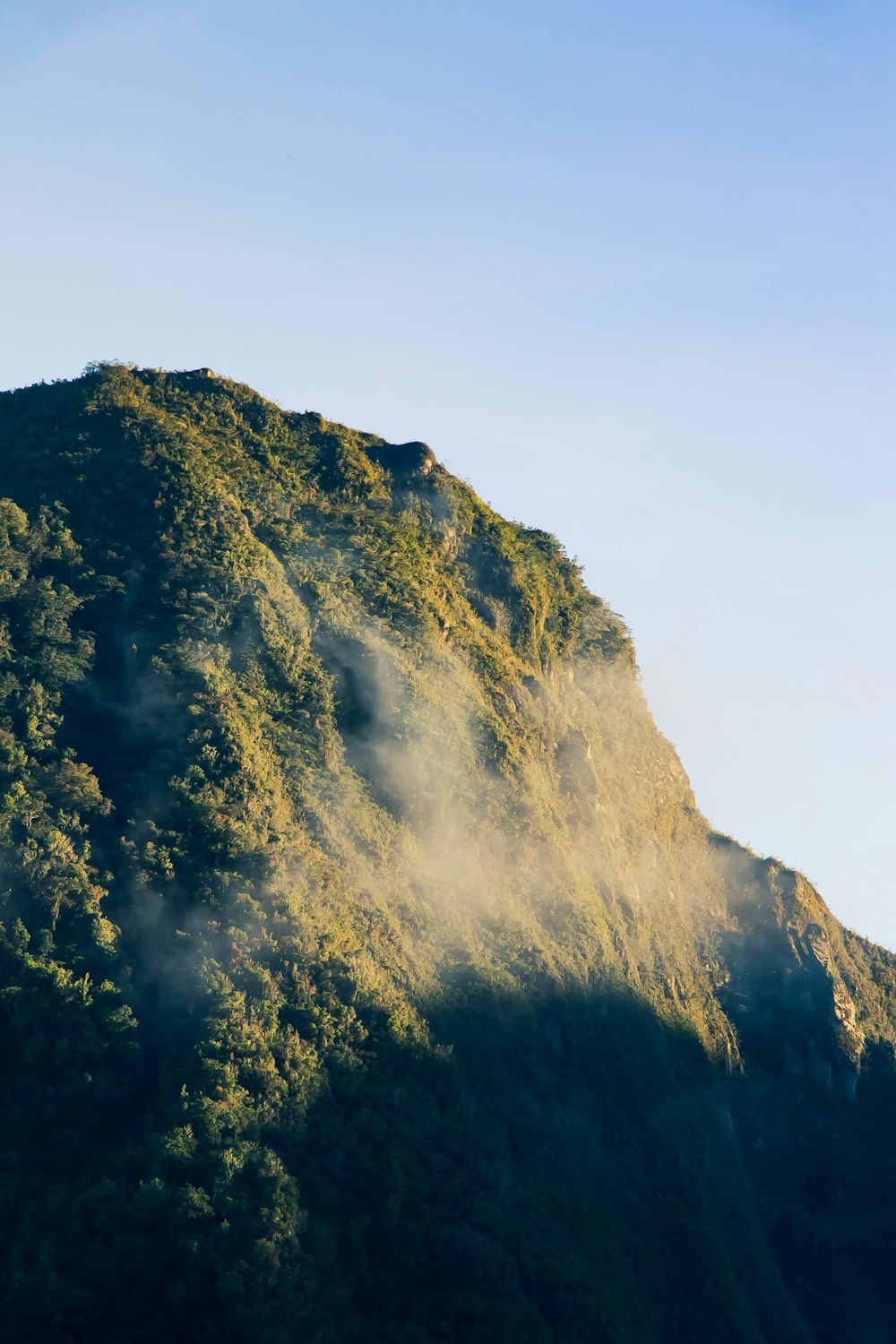 a very tall mountain covered in lots of fog