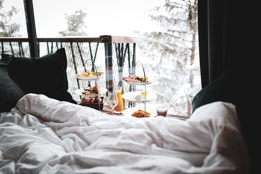 a bed with a tray of food on top of it