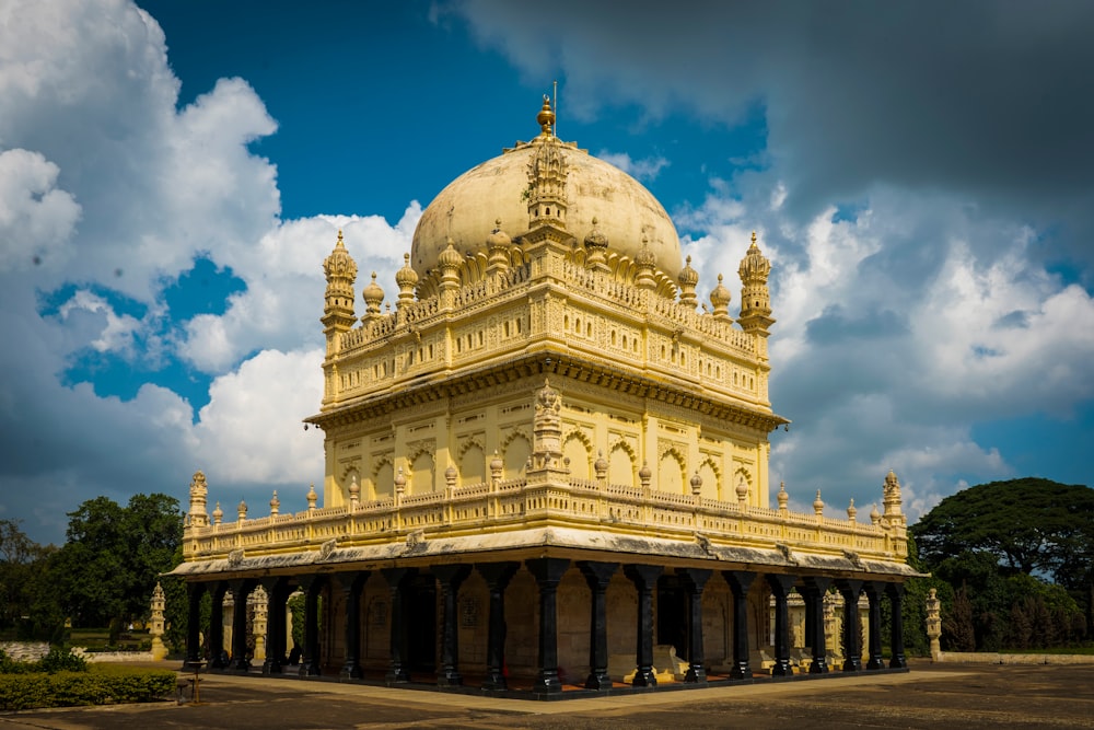 a large yellow building with a dome on top