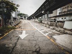 an empty street with a white arrow painted on it