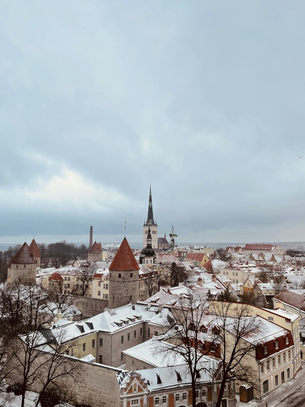 a view of a snowy city with a church steeple