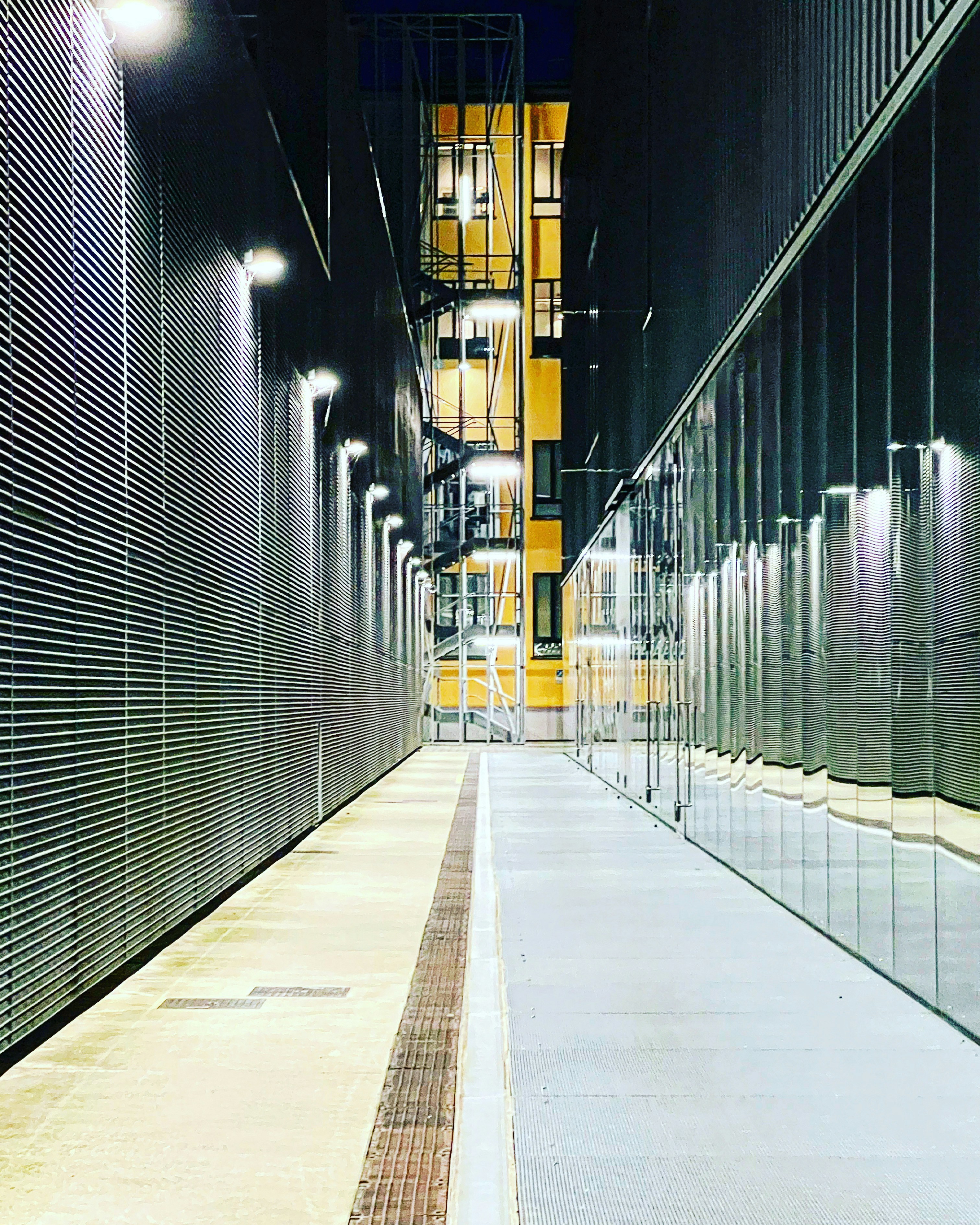 a long hallway with a clock on the side of it