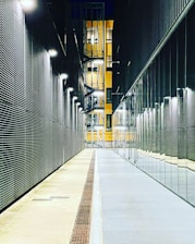 a long hallway with a clock on the side of it