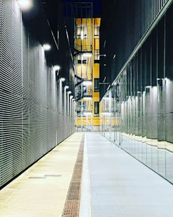 a long hallway with a clock on the side of it