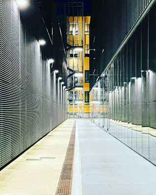 a long hallway with a clock on the side of it
