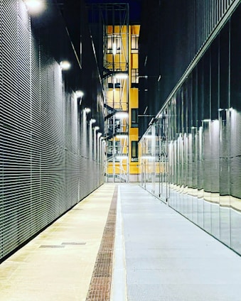 a long hallway with a clock on the side of it
