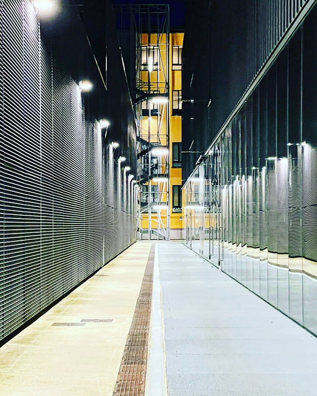 a long hallway with a clock on the side of it