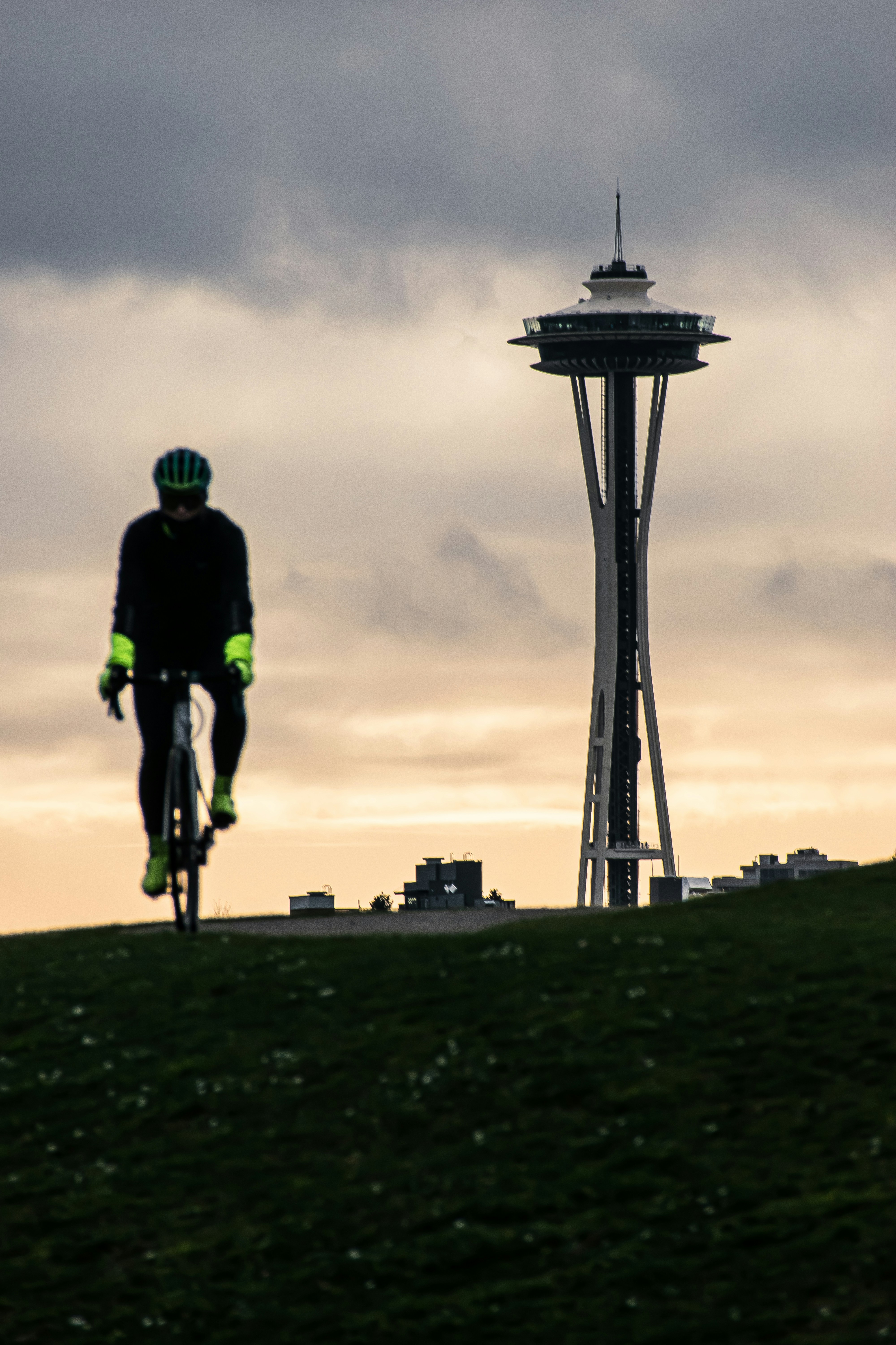 a man riding a bike down a lush green hillside
