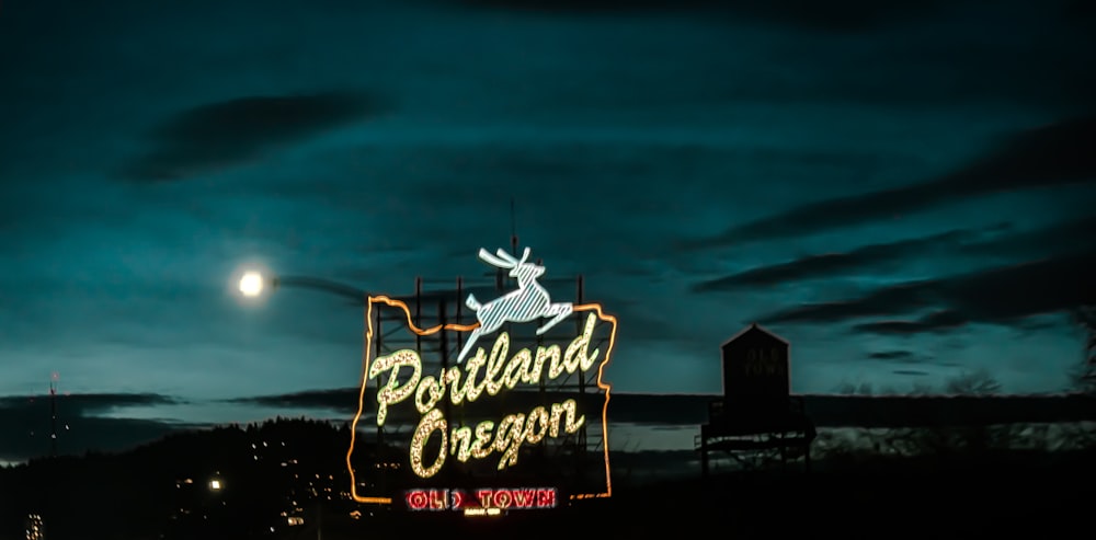 a neon sign that reads portland oregon at night