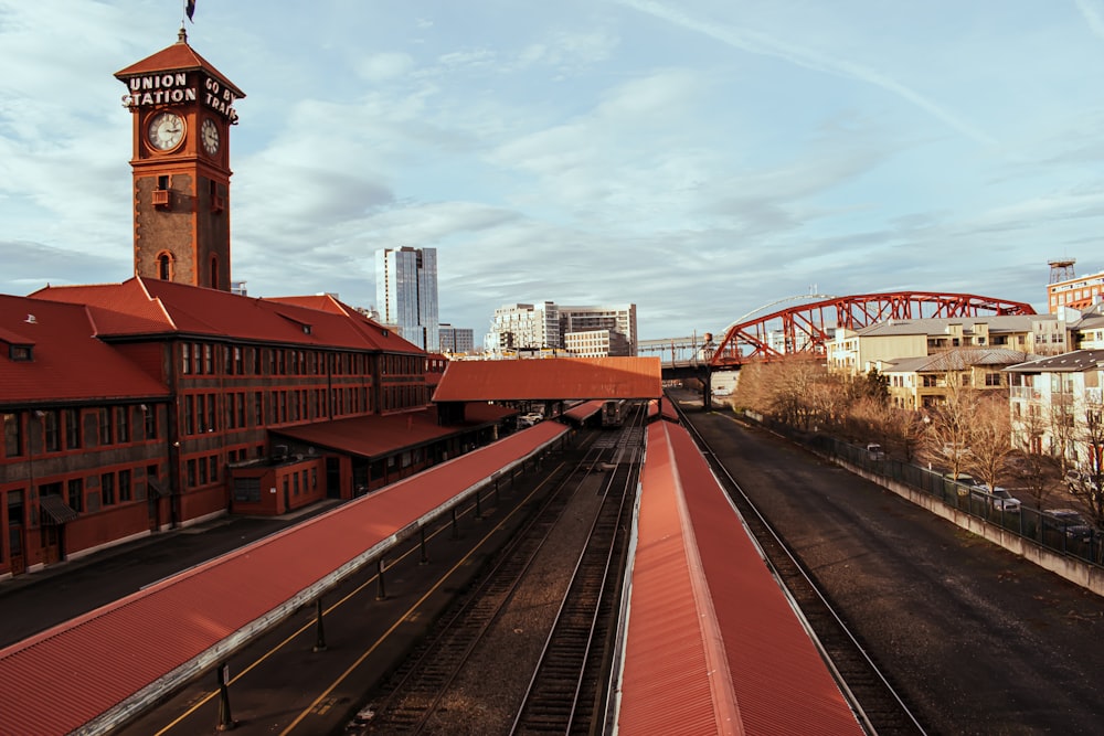 a train station with a clock tower in the background