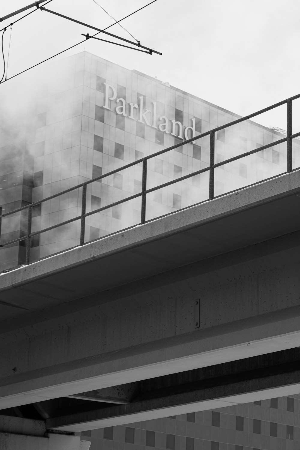 a black and white photo of a building with smoke coming out of it