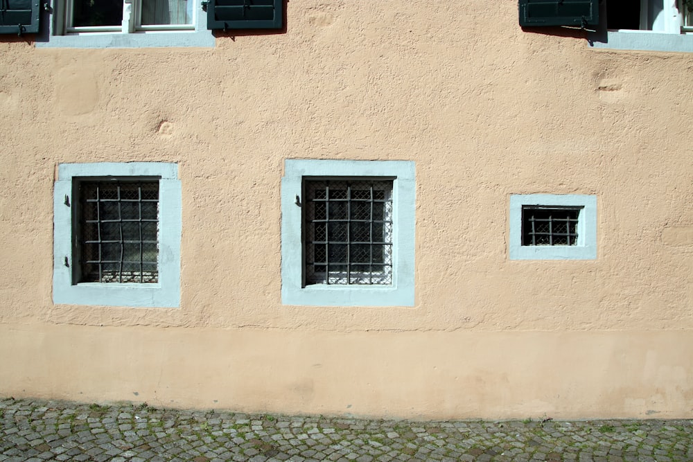 three windows on the side of a building